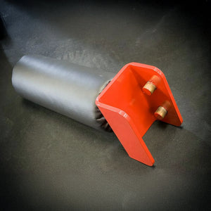 A black and red leg roller attachment sitting on a black rubber floor