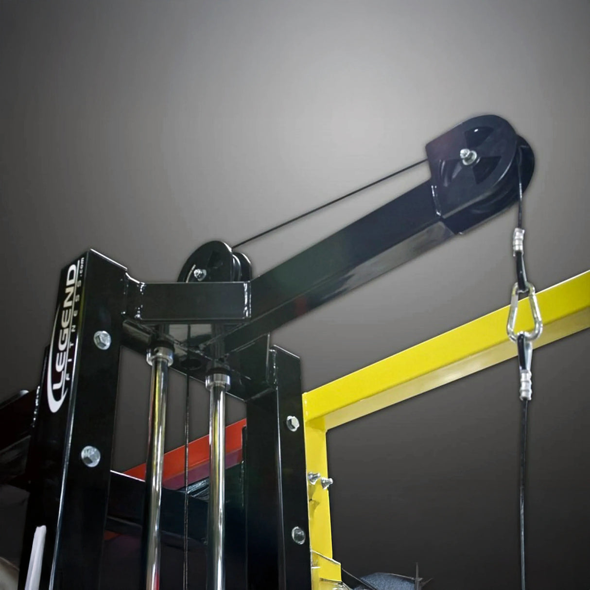 Black weightlifting pulley system with Legend Fitness branding on a gray wall.