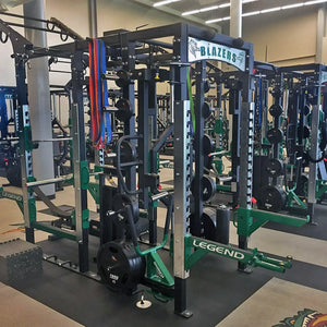 A red Legend Fitness half cage connected to the rear of a full cage