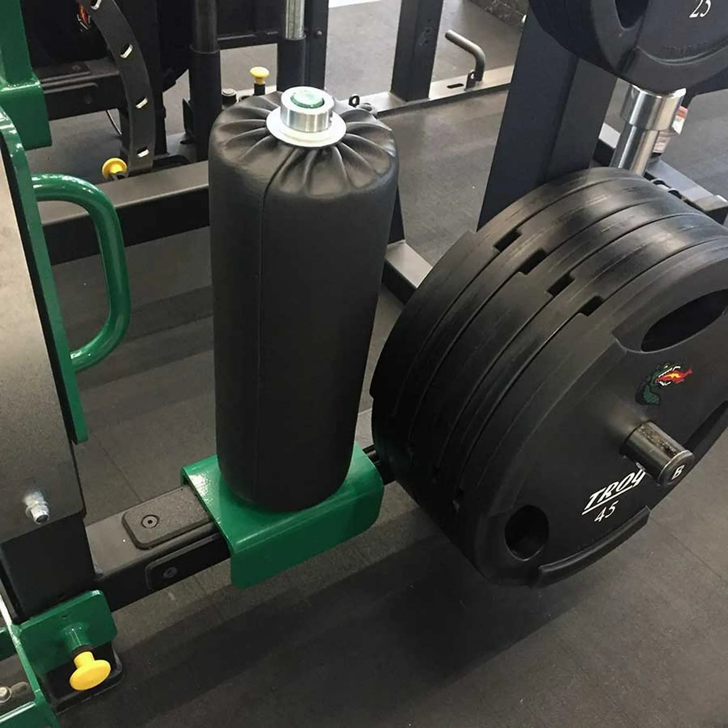 A leg roller attachment mounted on a Legend Fitness half cage