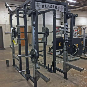 Rotating jammer arms connected to the top of a Legend Fitness weight lifting cage