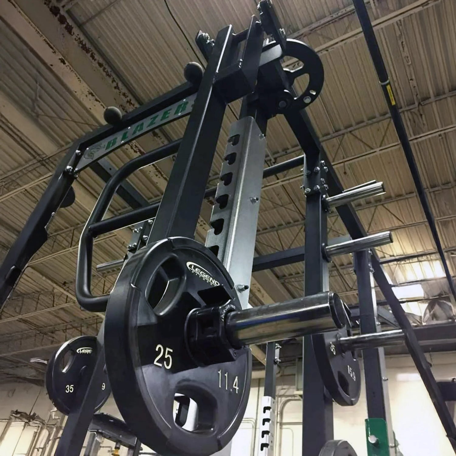Rotating jammer arms connected to the top of a Legend Fitness weight lifting cage