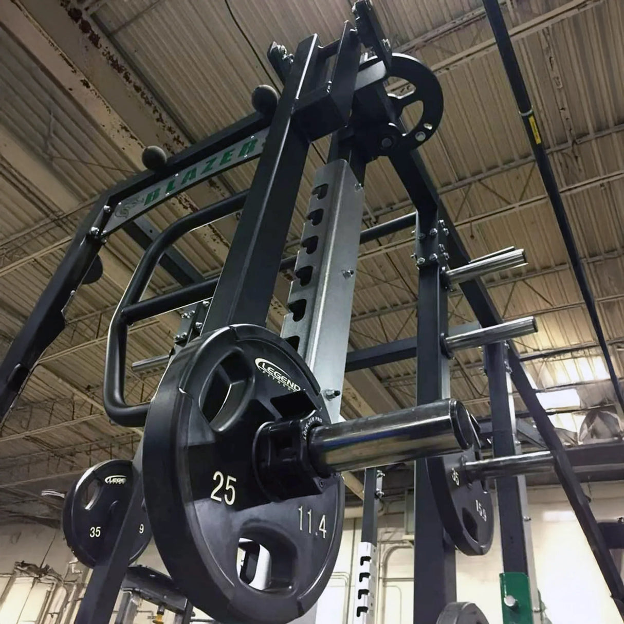 Rotating jammer arms connected to the top of a Legend Fitness weight lifting cage