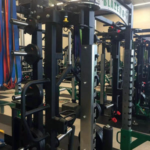 Rotating jammer arms connected to the top of a Legend Fitness weight lifting cage