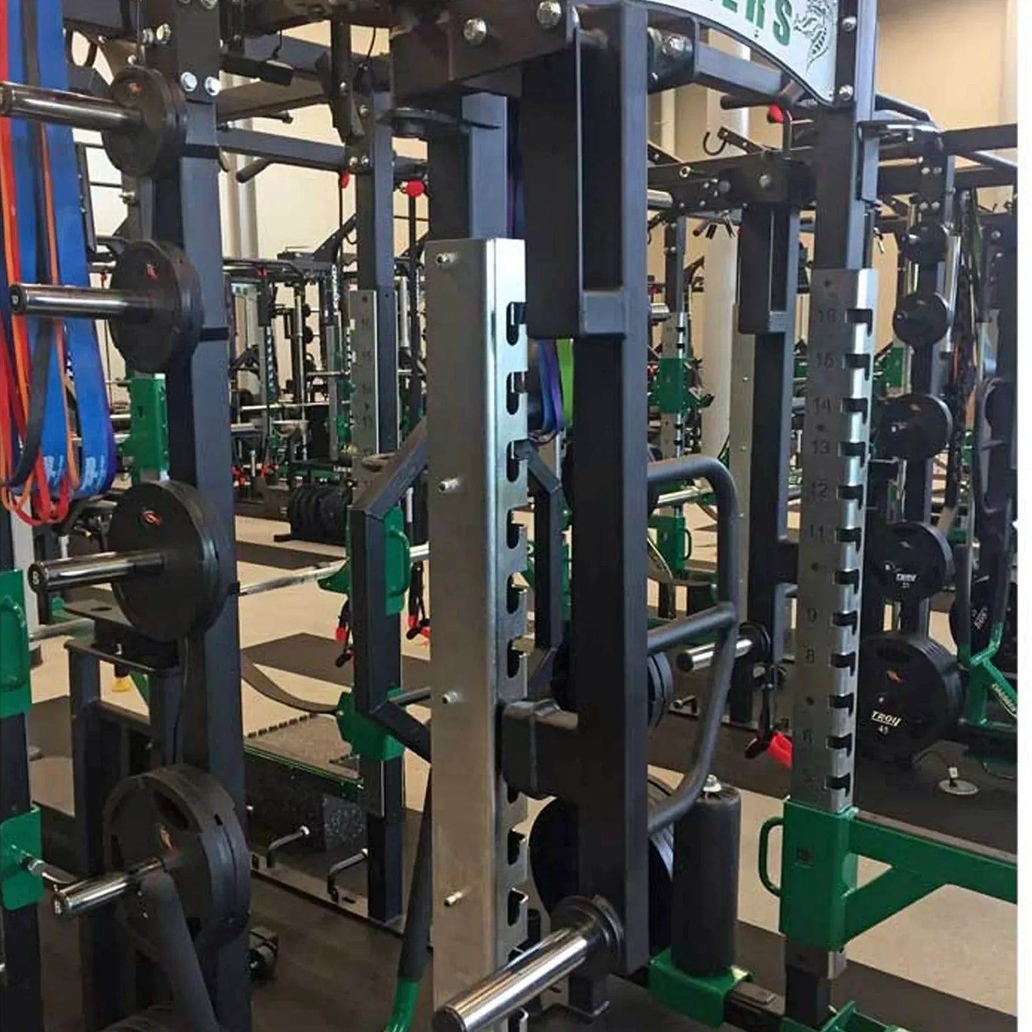 Rotating jammer arms connected to the top of a Legend Fitness weight lifting cage
