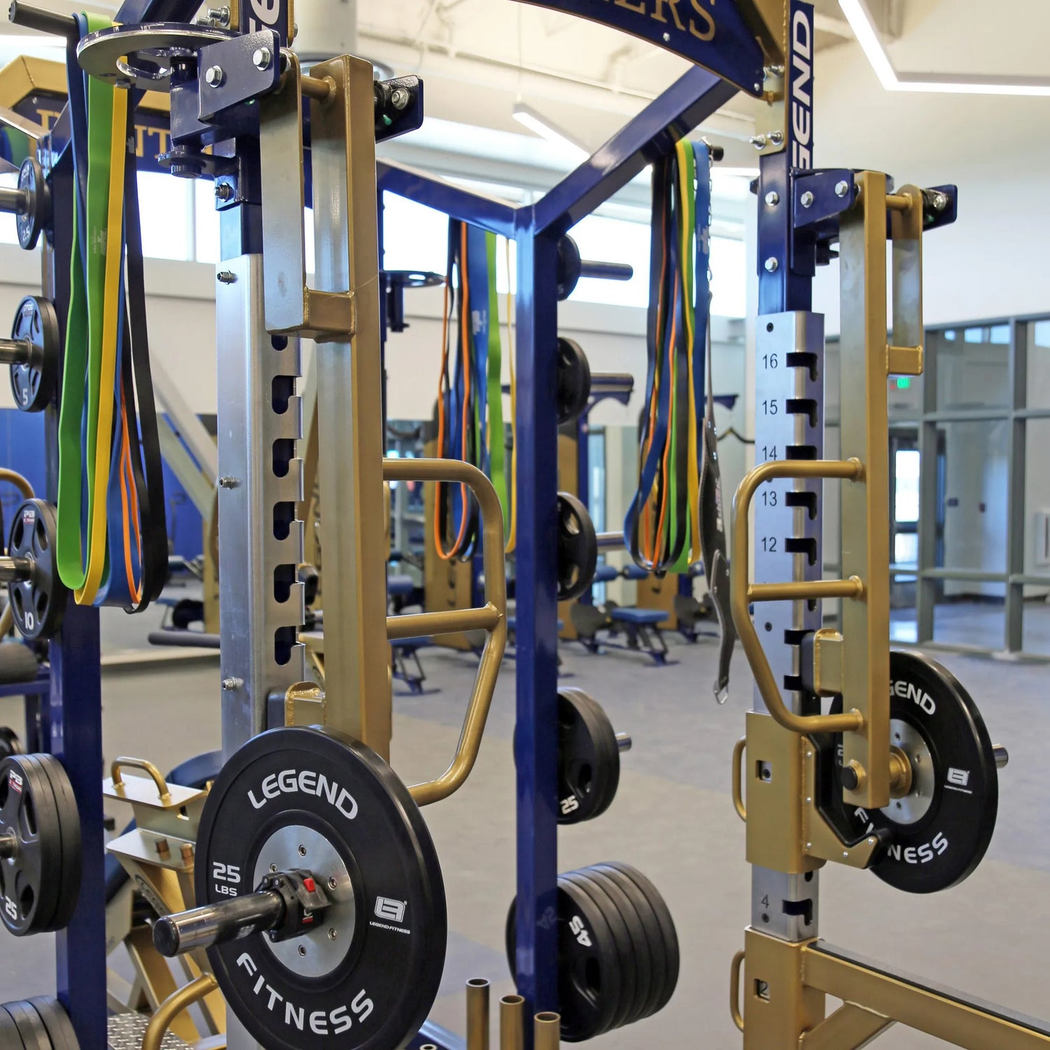 Rotating jammer arms connected to the top of a Legend Fitness weight lifting cage