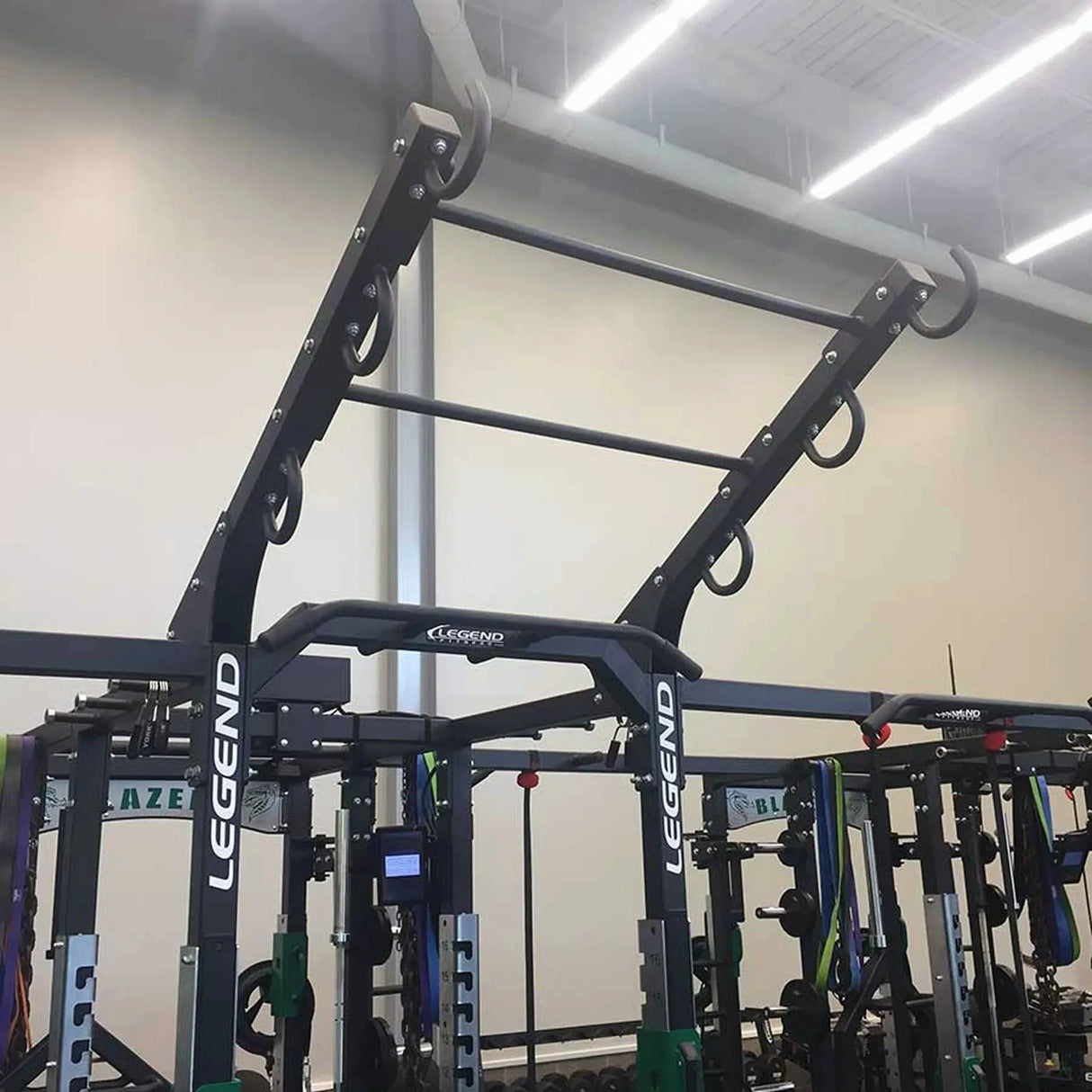 A ladder attachment connected to the top of a Legend Fitness weight lifting cage