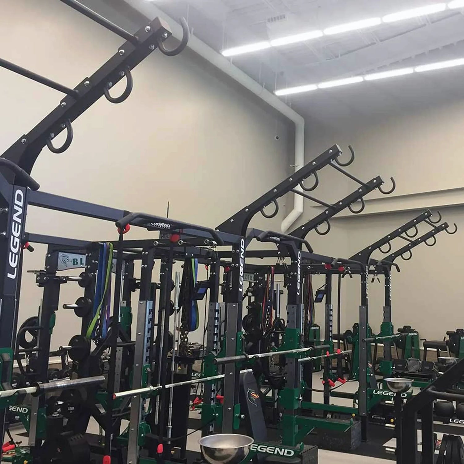 A ladder attachment connected to the top of a Legend Fitness weight lifting cage