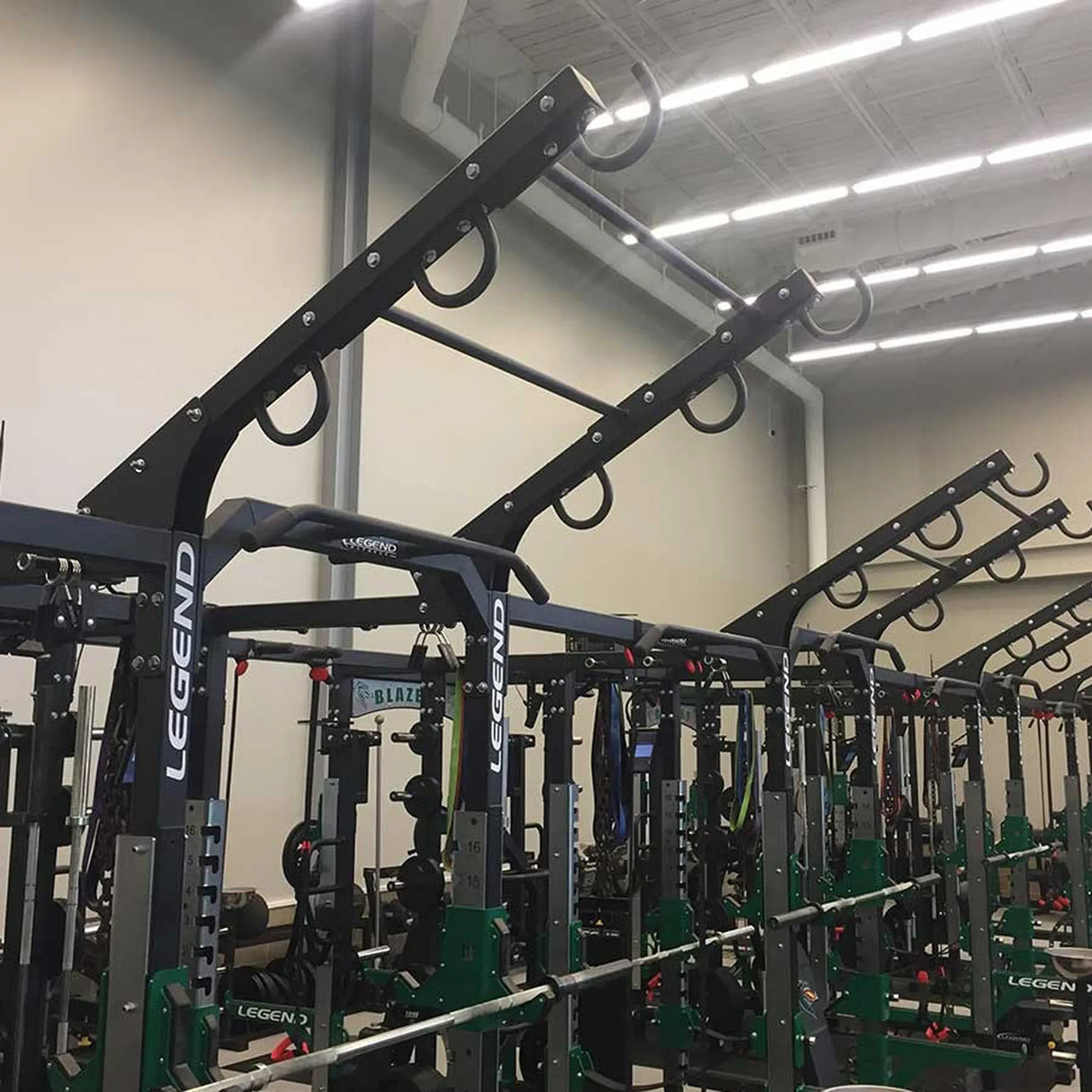 A ladder attachment connected to the top of a Legend Fitness weight lifting cage