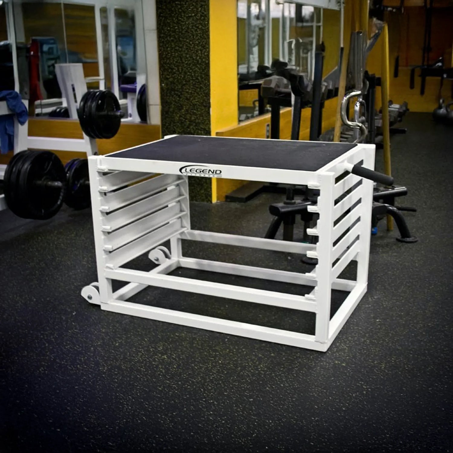 A white metal adjustable step up box in a gym setting