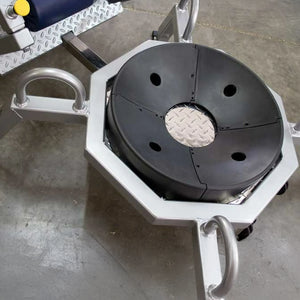 A gray metal frame from a piece of fitness equipment on a concrete floor