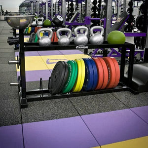 A black storage rack in a weight room with kettlebells on the top shelf and bumper plates on the bottom shelf