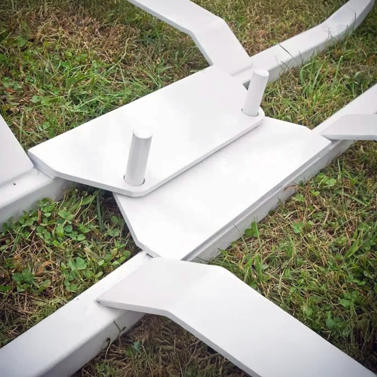 Close-up of a white metal frame on grass