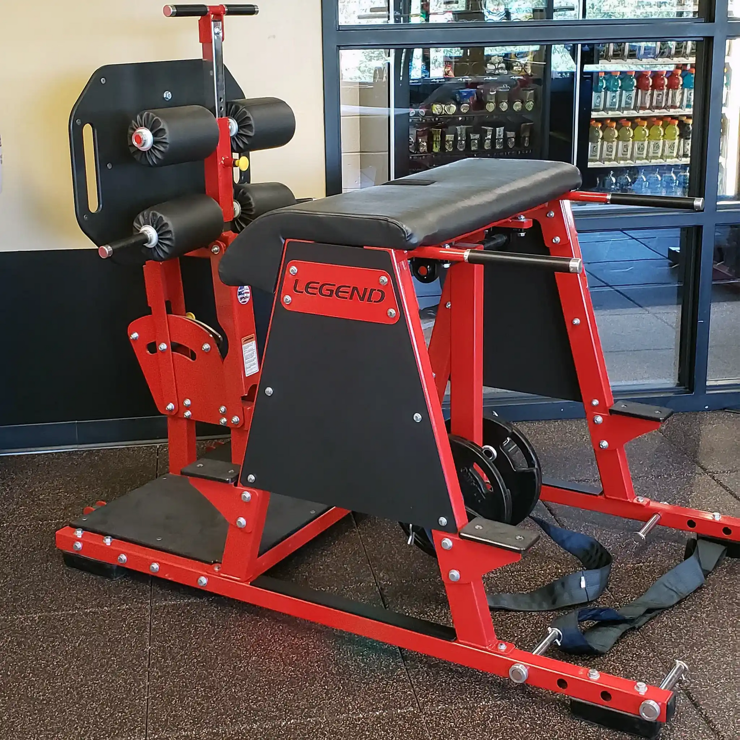 Red and black Legend Fitness machine in a gym setting.