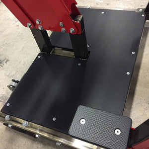 Black metal platform with red lever on a concrete floor