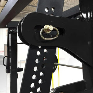 Close-up of a black metal bracket with a gold ring detail, blurred indoor background