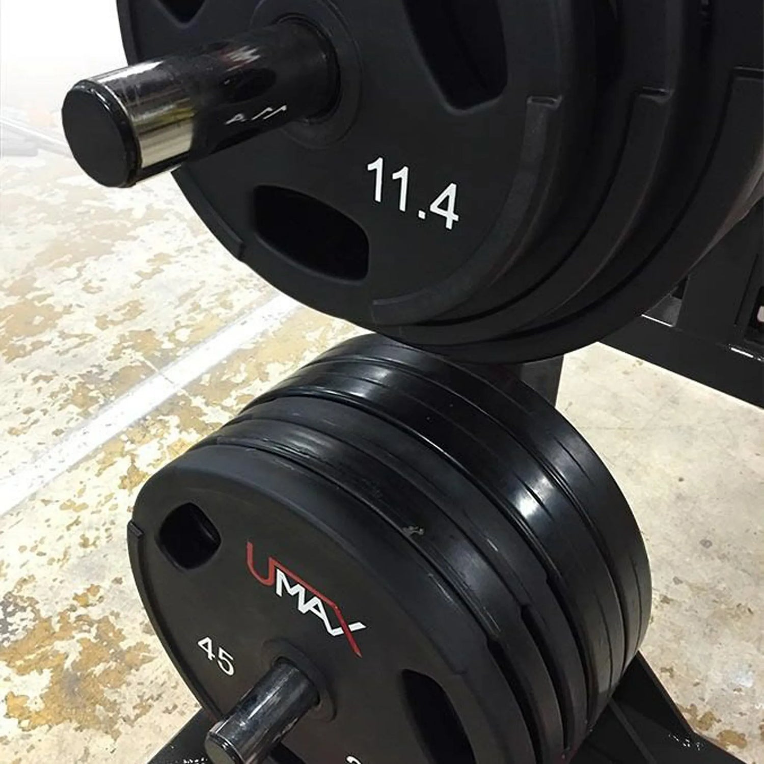 Closeup image of weight plates stored on silver storage pegs