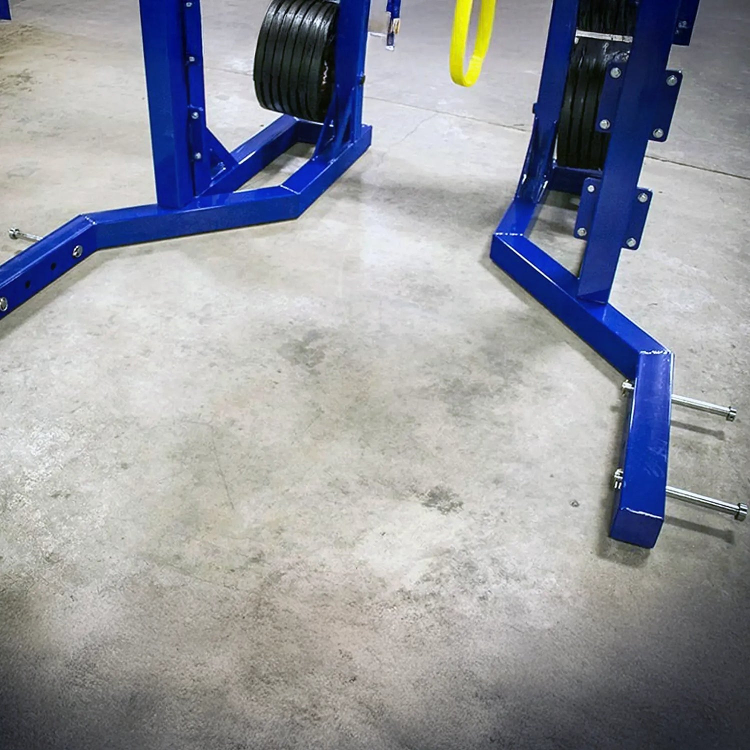Blue weightlifting stand with weights on a concrete floor