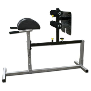 A silver glute ham developer with black pads on a white background