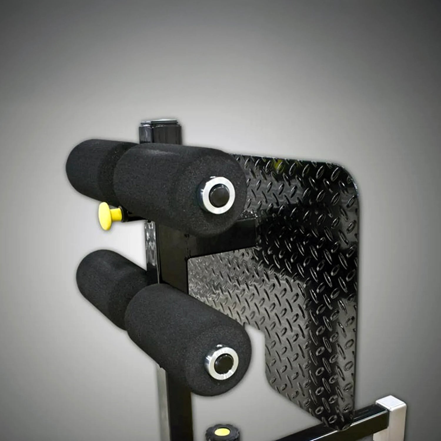 Close-up of a mechanical component with textured surface and black and yellow parts on a gray background