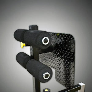 Close-up of a mechanical component with textured surface and black and yellow parts on a gray background
