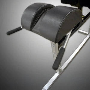 A black upholstered pad on a silver metal frame on a gray background