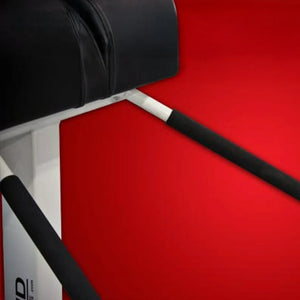 Black upholstered pads and a white metal frame on a red background