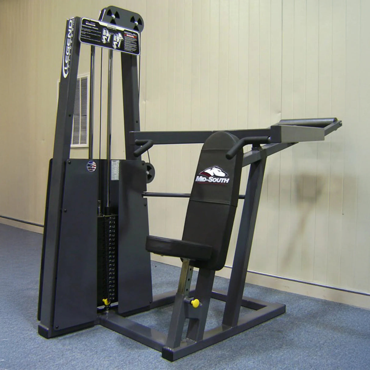 The Legend Fitness 902 Shoulder Press Machine by Legend Fitness features a padded seat, backrest, and two horizontal handles, plus weight plates on the left side for adjustable resistance.
