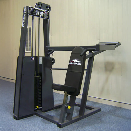 The Legend Fitness 902 Shoulder Press Machine by Legend Fitness features a padded seat, backrest, and two horizontal handles, plus weight plates on the left side for adjustable resistance.