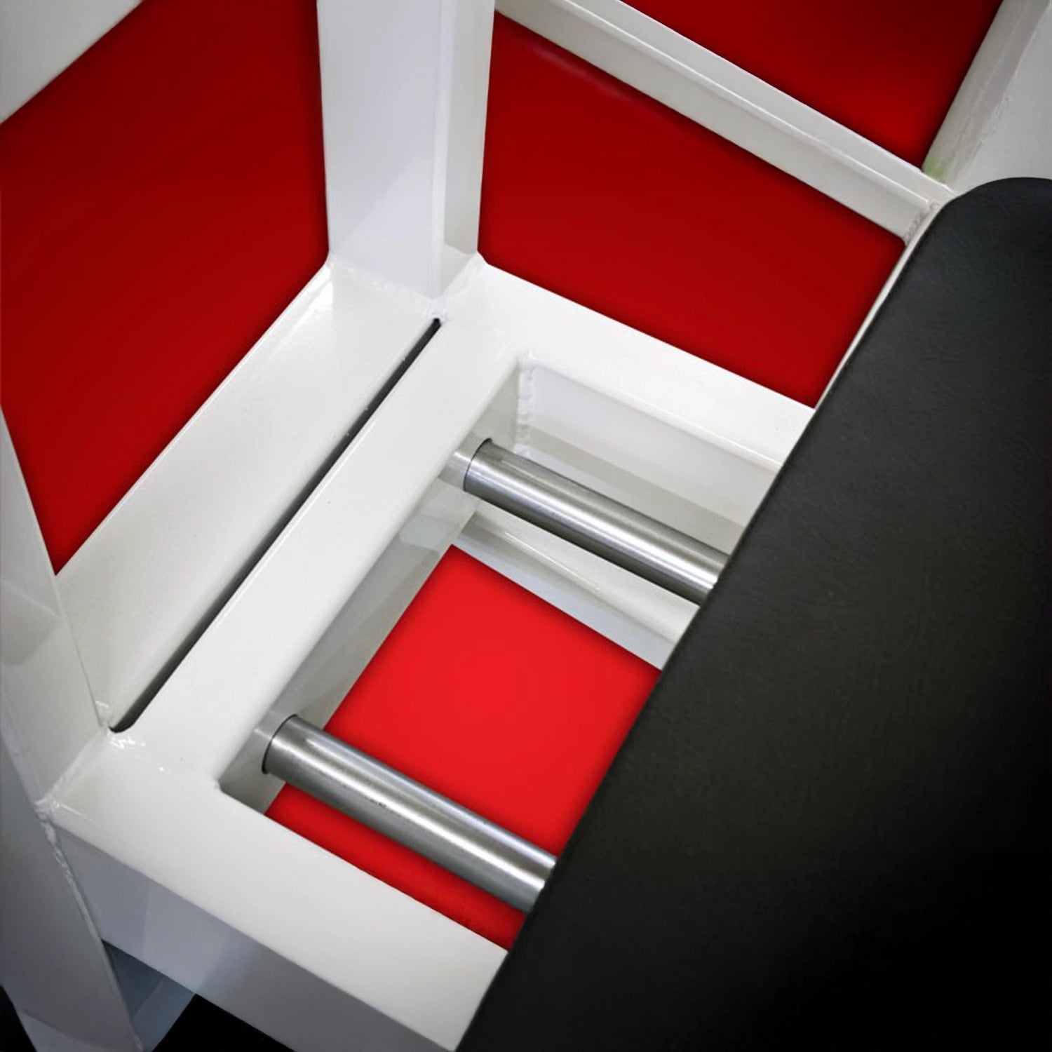 Close-up of the Legend Fitness 914 Supine Leg Press Machine by Legend Fitness, featuring shiny metal bars, a white frame, red panels, and a black padded section visible on the right.