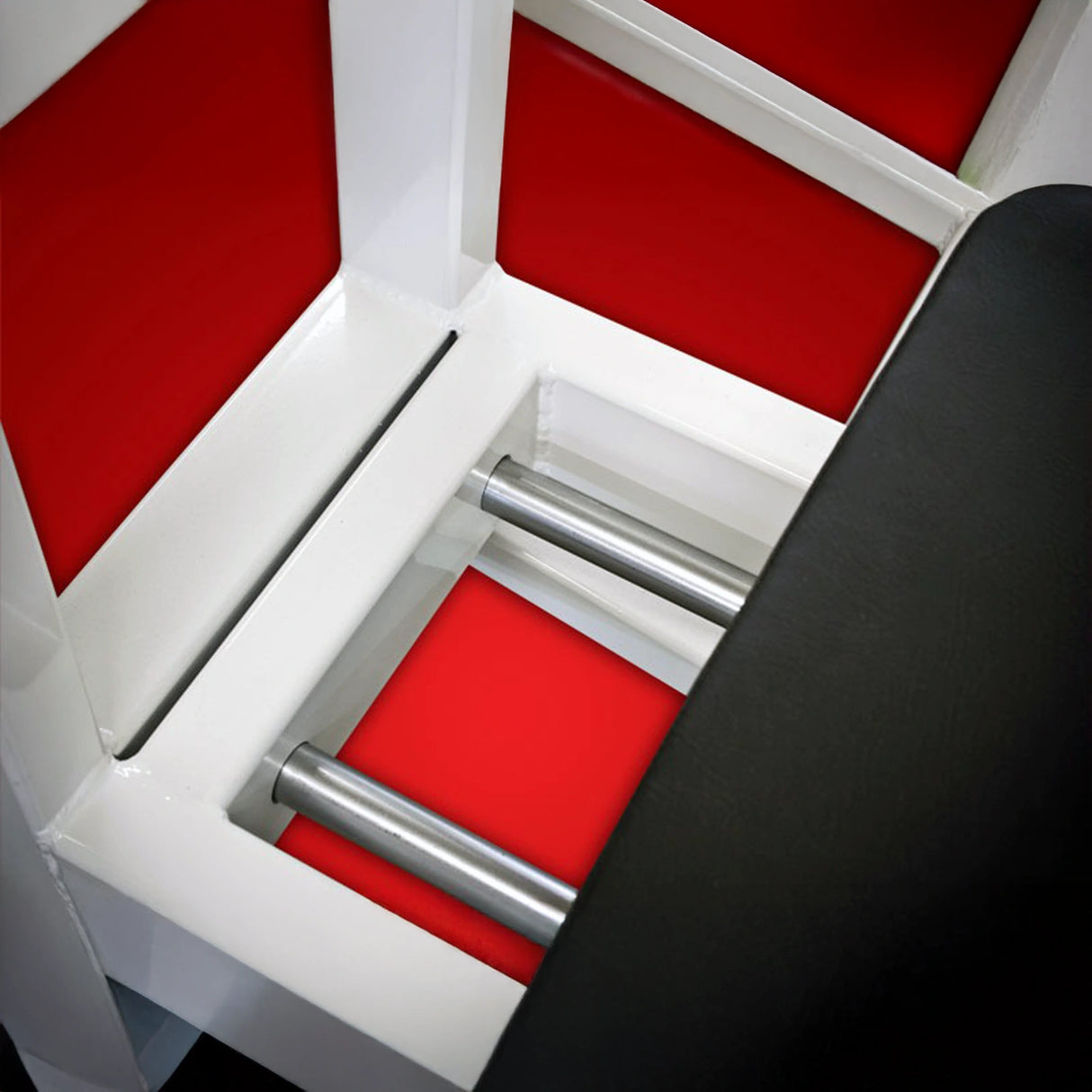 Close-up of the Legend Fitness 914 Supine Leg Press Machine by Legend Fitness, featuring shiny metal bars, a white frame, red panels, and a black padded section visible on the right.