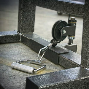 A close-up of the Legend Fitness 919 Cable Crossover Machine by Legend Fitness, highlighting the metal handle attachment linked to its pulley system on a textured metal frame.