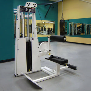 A Legend Fitness 957 Low Back / Ab Combo Machine stands in an empty gym with mirrors, yellow and green walls, and a hanging punching bag in the background.