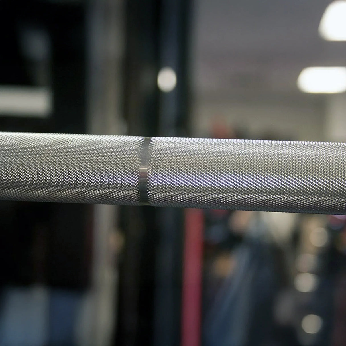 Close-up of a textured metal bar with a blurred background