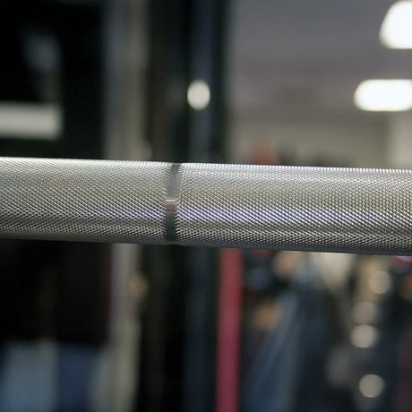 Close-up of a textured metal bar with a blurred background