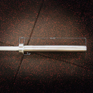 Metal bar with measurements on a black and red speckled rubber floor.