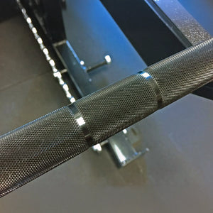 Closeup of a barbell metal knurling.