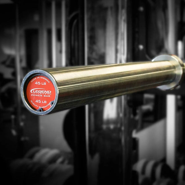 Silver barbell with red label on a blurred gym background