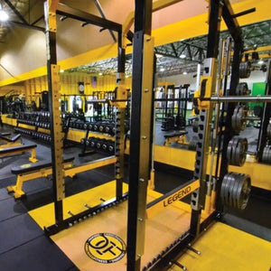 Gym interior with weightlifting equipment, including a Legend Fitness power rack.