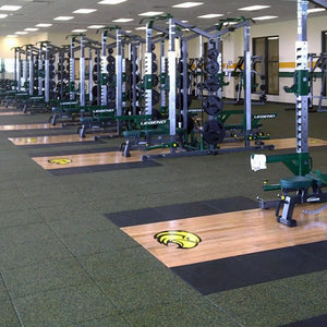 Gym with weight lifting equipment and marked floor areas