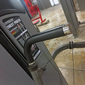 Close-up of a Legend Fitness chest press machine in a gym setting.