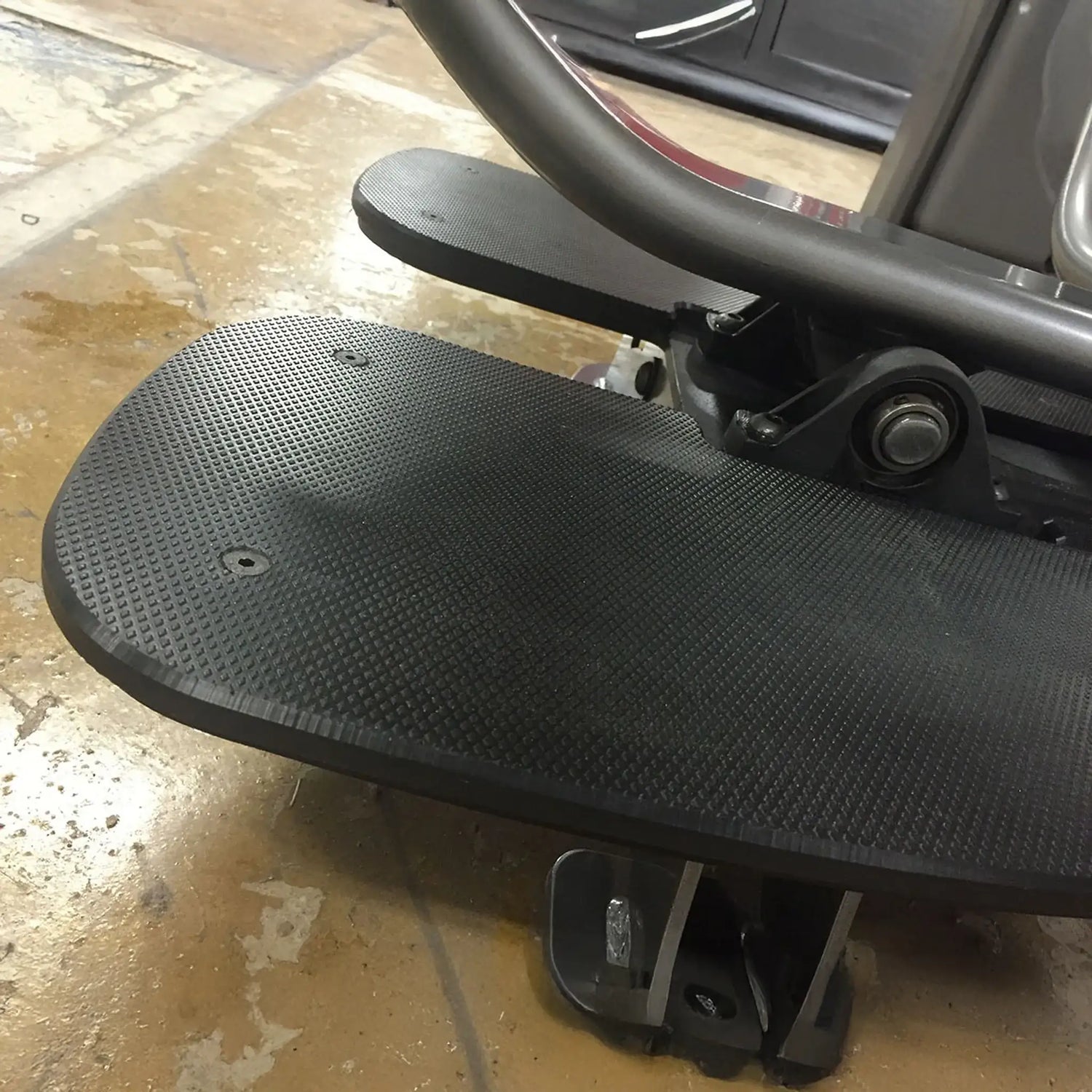 Close-up of a black foot plate on a piece of fitness equipment