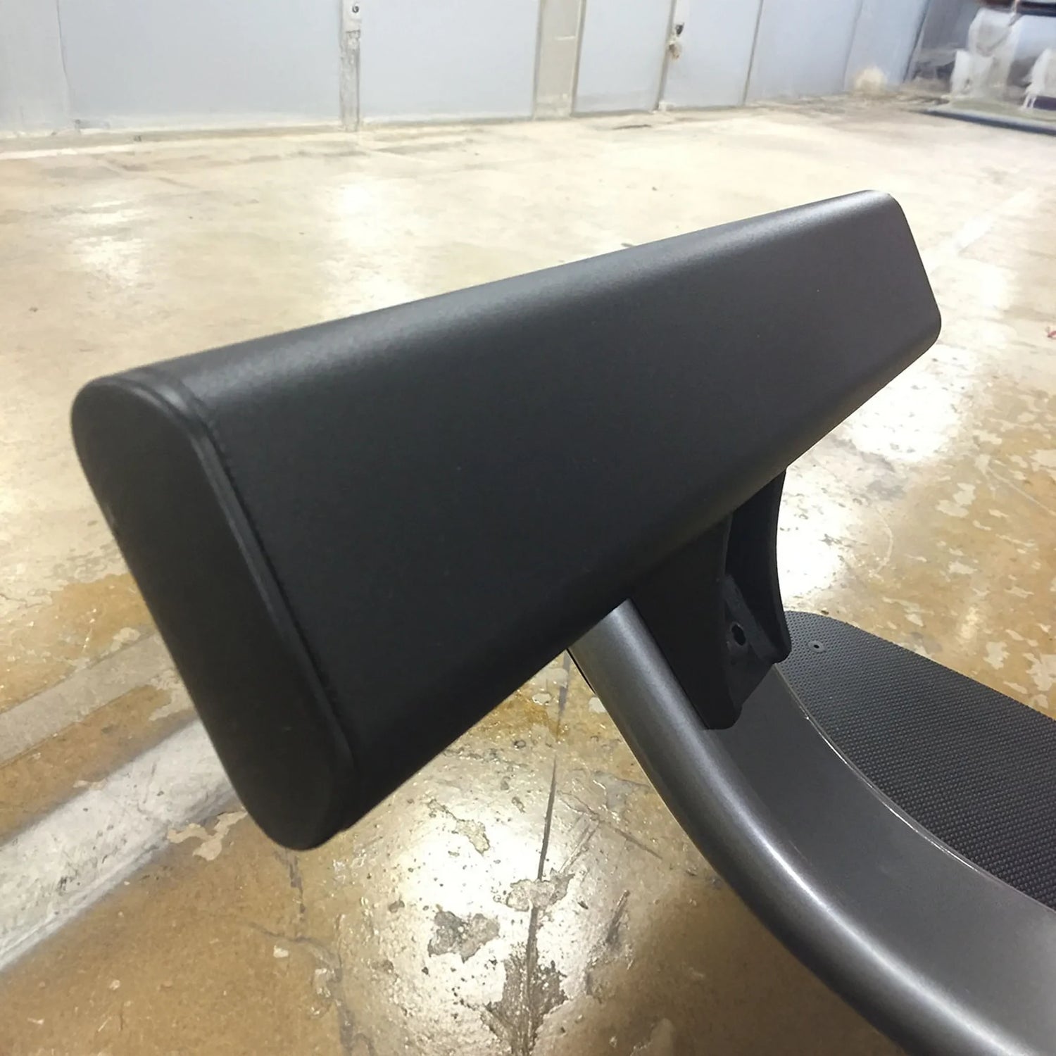 Black footrest on a piece of gym equipment