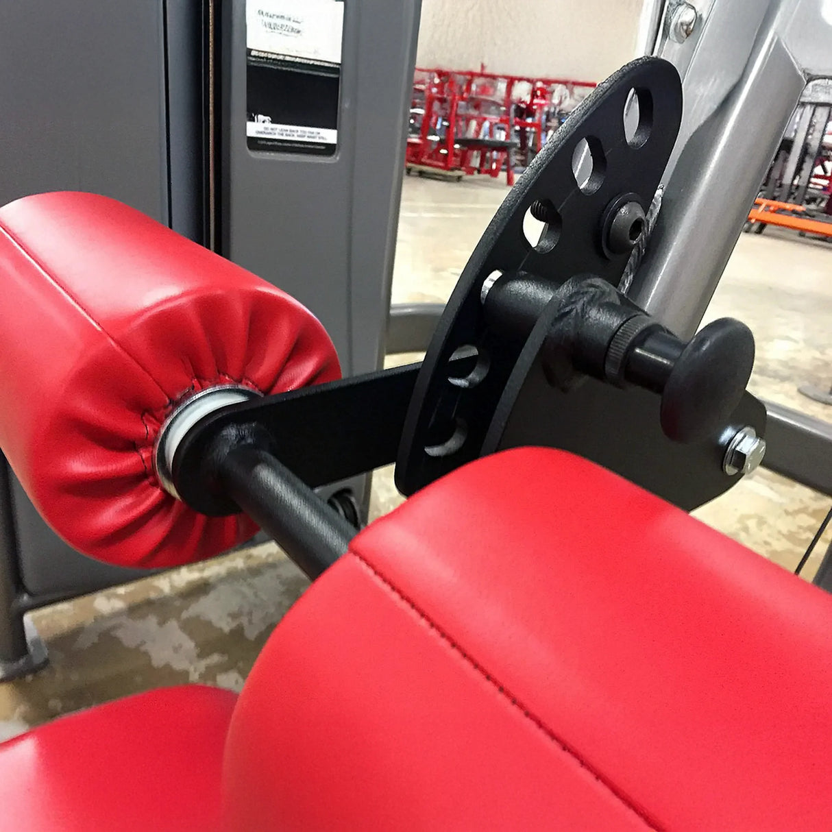 Close-up of red roller pads on a piece of gym equipment