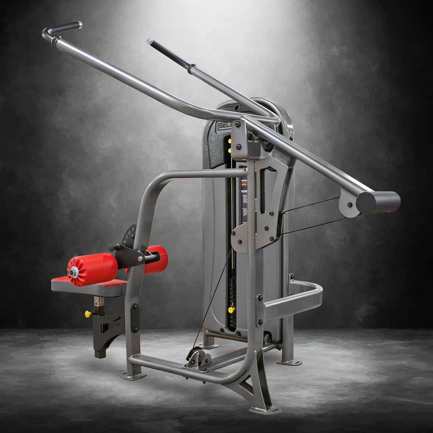 Gym machine with red padding on a dark background