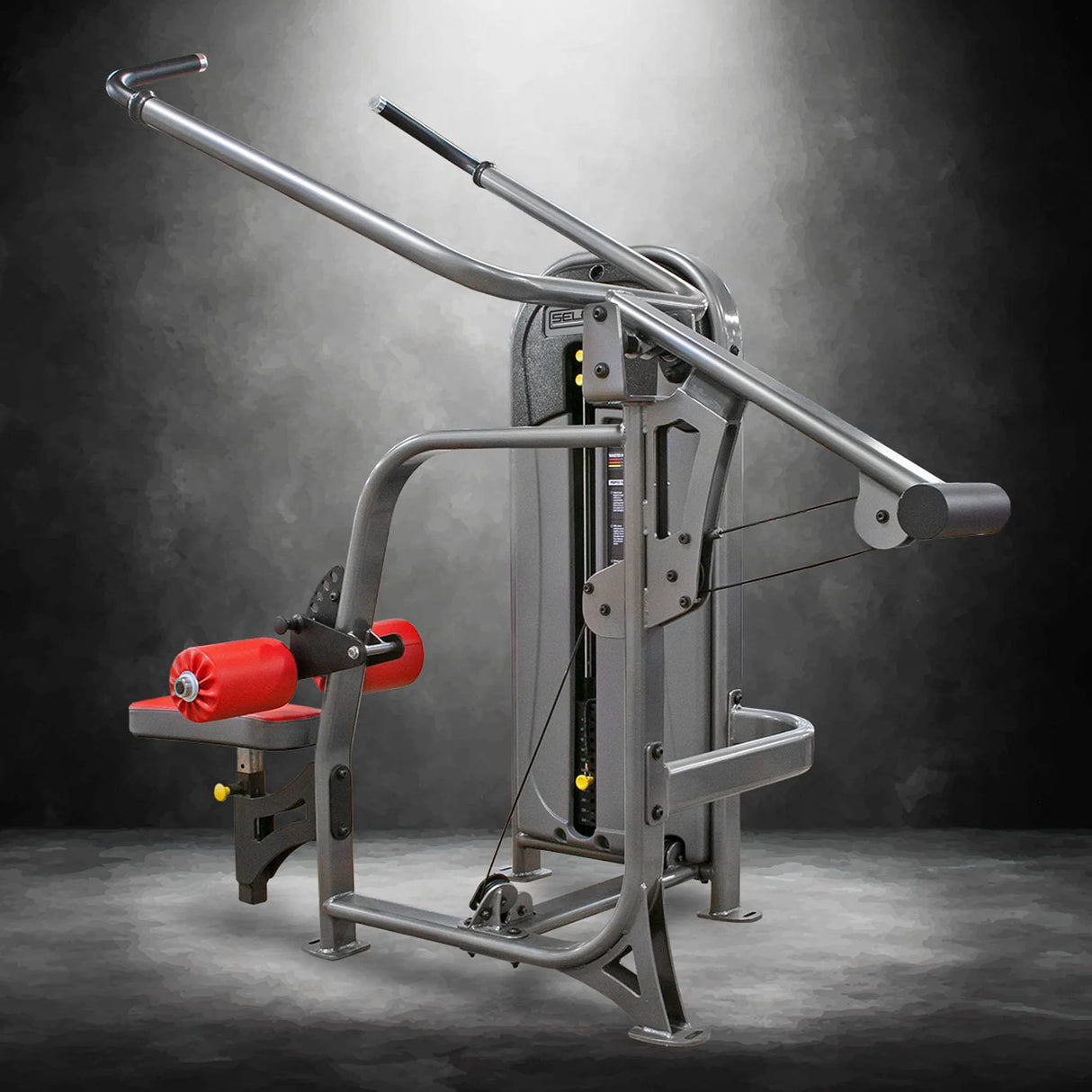 Gym machine with red padding on a dark background