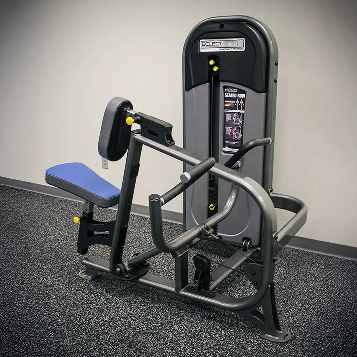 Gym machine with blue seat on a gray floor against a white wall