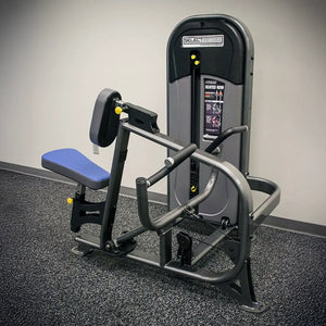 Gym machine with blue seat on a gray floor against a white wall