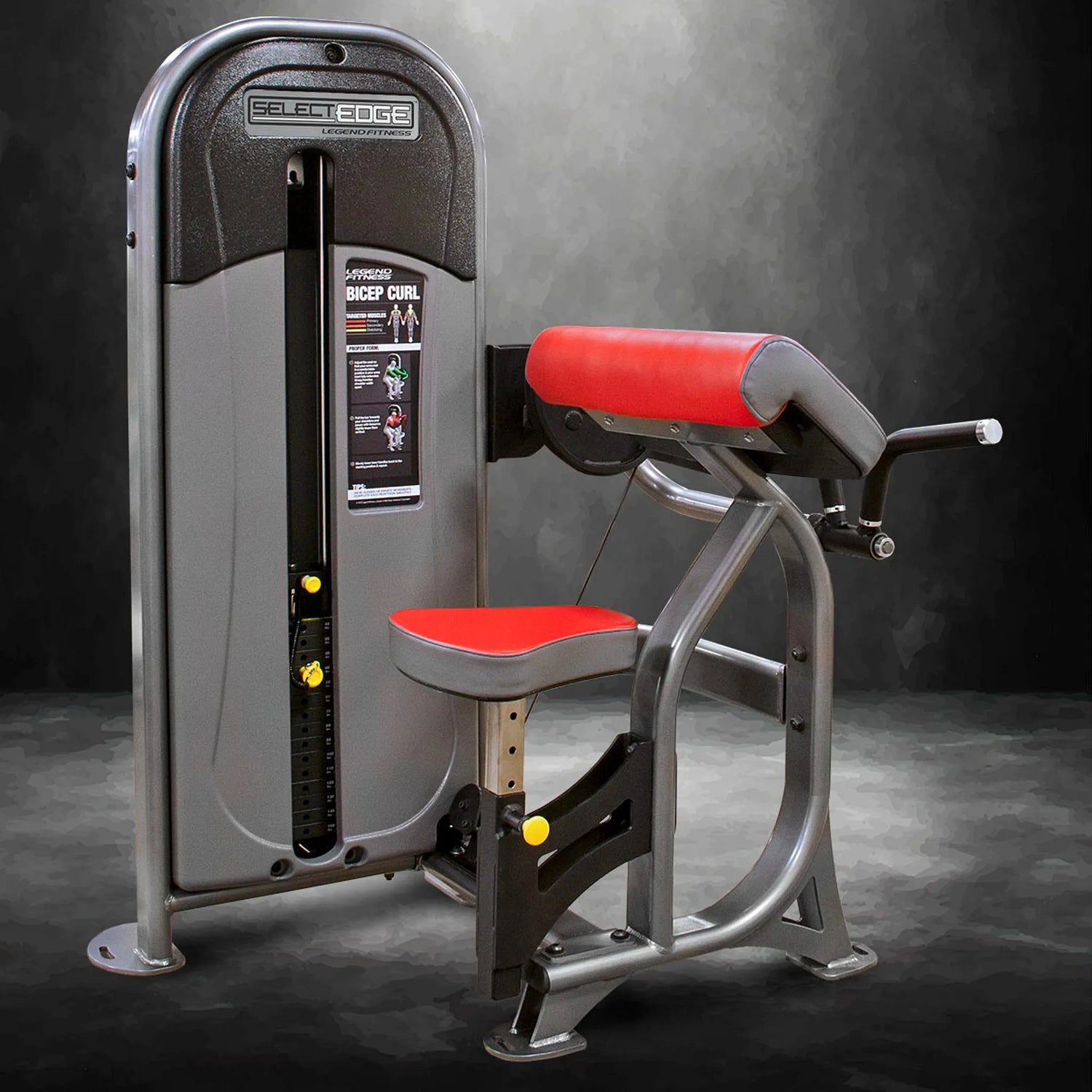 Gym machine with red seat and gray frame on a dark background