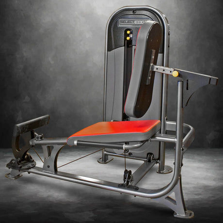 Gym machine with red seat and gray metal frame on a gray background